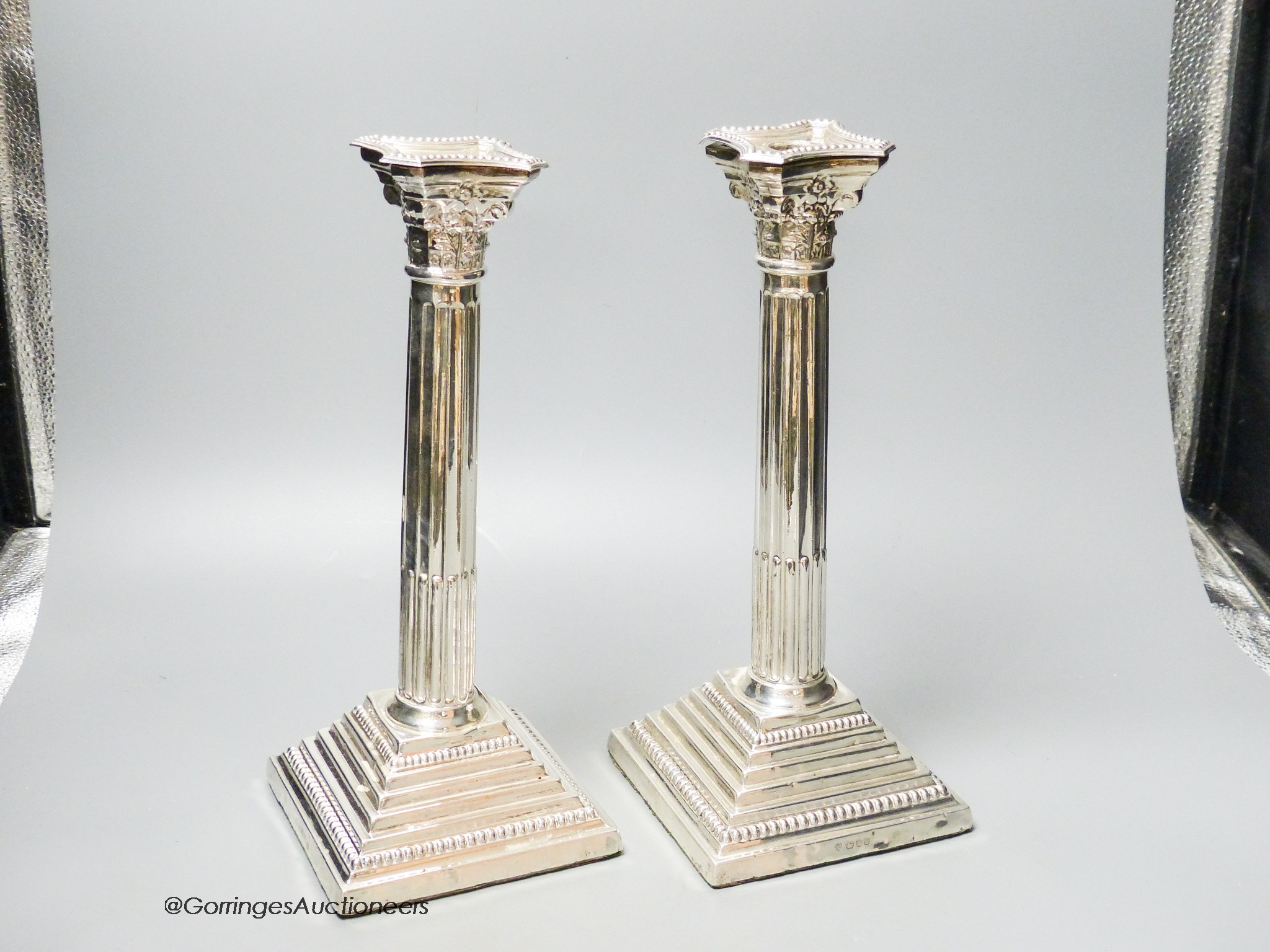 A pair of 1960's silver Corinthian column candlesticks, D J Silver Repairs, London, 1967, 30cm, weighted (a.f.).